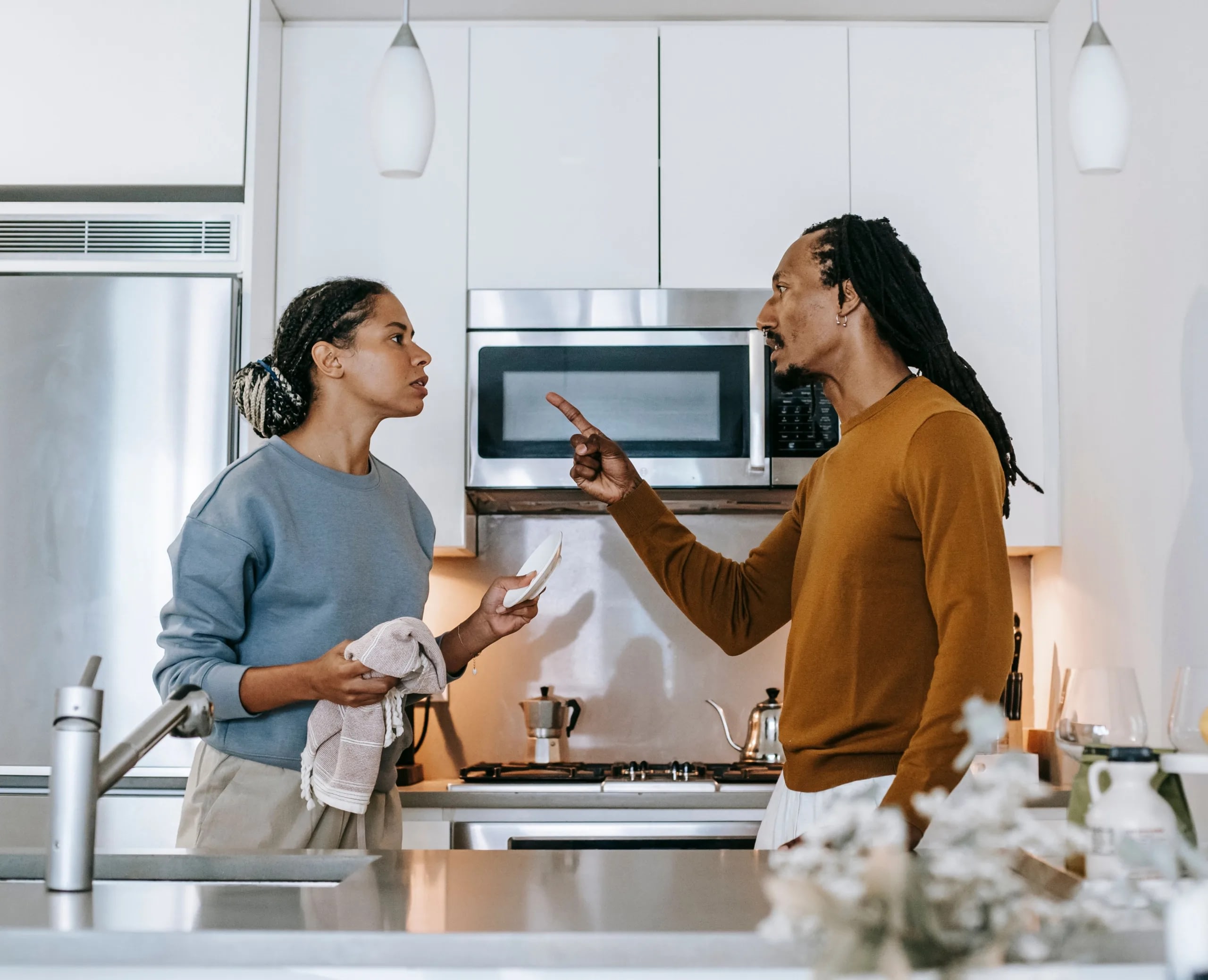 high-conflict-couple Couple in conflict in the middle of their kitchen.