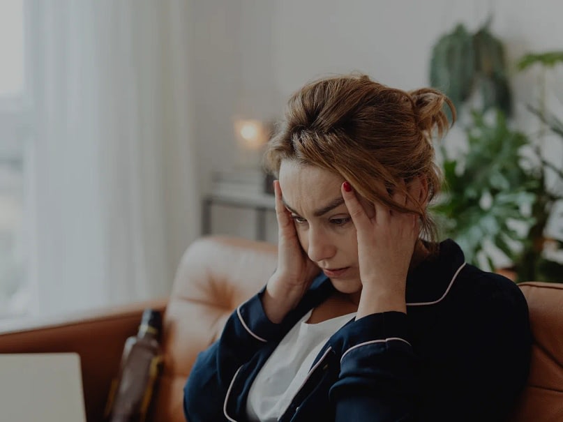 A stressed woman who looks confused and tired.